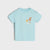 A light blue short-sleeve baby t-shirt with a small graphic of a yellow sun, orange palm tree, and white waves on the chest, displayed against a light gray background.