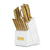 A gold-tone kitchen knife set with matching shears in a modern white block knife block, featuring a gold brand plaque on the front.