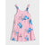 A pink sleeveless tiered dress featuring an all-over cartoon character print of blue and pink creatures, shown against a light gray background.