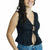 A woman wearing a black sleeveless lace-trimmed top with a tie-front detail and ruffled hem, paired with blue jeans, against a plain white background.
