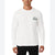 A man wearing a white long-sleeve crewneck sweatshirt with a green and navy Lacoste crocodile logo on the left chest, paired with black pants, against a plain white background.