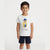 A young boy modeling a white short-sleeve t-shirt with a colorful graphic of a bear wearing a yellow raincoat and blue hat, paired with navy blue shorts, against a plain light gray background.