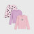 Three girls' long-sleeve tops in pink and lavender shades, displayed in a layered flat-lay arrangement on a light gray background. The top-left shirt is light pink with black heart prints, the middle shirt is lavender, and the bottom-right shirt is light pink with ruffled shoulders and a small elephant graphic on the chest.