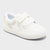 White sneaker with velcro straps on a light gray background