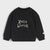 A black long-sleeve crewneck sweatshirt for toddlers, featuring the words 'Hello World!' printed in white script across the chest, displayed on a light gray background.