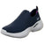 A navy blue knit slip-on sneaker with a thick white sole, featuring the Skechers logo on the side and a purple interior lining.