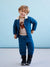 Child wearing a blue quilted outfit with a dinosaur sweater against a light blue background