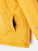 Close-up of a yellow jacket with a pocket on a white background