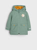 Green raincoat with orange interior lining and logo on a white background