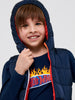 Child wearing a navy blue puffer jacket with a colorful inner lining, smiling against a white background.
