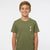 A smiling young boy with short blond hair wearing an olive green crewneck t-shirt with a small beige graphic on the left chest, photographed against a solid light gray background.