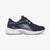 A navy blue Ryka athletic sneaker with gray mesh panels and a thick white sole, shown in a side profile on a light gray background.