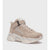 A single mid-top chunky sneaker in beige suede and synthetic materials, featuring a hook-and-loop strap across the instep, a ribbed knit collar, and a thick sculpted chunky sole in cream and light gray, shown against a plain light gray background.