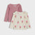 Two long-sleeve girls' tops layered together on a light gray background. The top behind is dusty pink with ruffle trim at the shoulders.