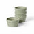 Five small round ceramic ramekins in a muted sage green color, with four stacked and one standing in front, on a clean white background.