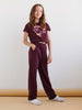 Person wearing a maroon outfit with text on a plain background