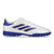 A white Adidas soccer turf shoe with royal blue stripes and sole, accented by thin red lines along the stripes.