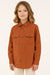 Child wearing a brown shirt with button details on a plain background