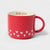 A red ceramic mug with a white interior, featuring the words 'love you' printed in red on the inside rim and a pattern of small white hearts along the lower exterior. The mug is shown on a clean, light gray background.