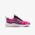 A Nike running shoe in vibrant pink and black with a white midsole, shown from a side profile on a light gray background.