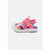 A single children's sandal in bright pink with multicolor cartoon-style graphics, a hook-and-loop strap closure, and a thick white sole, shown against a light gray background.