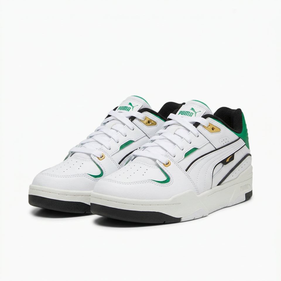 A pair of white low-top sneakers with green, black, and gold accents, displayed on a light gray background.