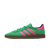 Green and pink Adidas sneaker on a white background