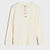 An off-white ribbed long-sleeve henley shirt with three brown buttons, shown flat against a light gray background.