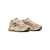 Pair of beige sneakers with a brand logo on a white background