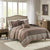 Bedroom with patterned comforter on a bed, nightstands, and a dresser.