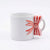 A white ceramic mug featuring a 3D handle shaped like a red and white striped candy cane bow, set against a plain white background.