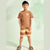 A young boy modeling a two-piece casual set consisting of a brown short-sleeve t-shirt with a white graphic on the chest and matching brown and beige striped shorts, standing against a light mint green background with soft palm leaf shadows.