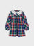 Plaid dress with a white collar on a light gray background