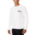 A man wearing a white long-sleeve crewneck shirt with a green and navy Lacoste crocodile logo on the left chest, paired with black pants, against a plain white background.