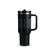 A black Stanley travel tumbler with a handle, a textured grip band, and a clear lid, shown on a plain white background.