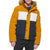 A model wearing a Tommy Hilfiger colorblock puffer jacket with a mustard yellow body, a white chest stripe, a navy blue lower section, and a brown faux-fur hood trim.
