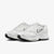White athletic shoes with black soles on a white background
