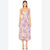 A woman modeling a sleeveless midi dress with thin straps and a purple, yellow, and beige abstract watercolor print, standing against a plain white background.