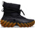 Black winter boot with brown sole on a white background