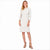 A woman modeling a white and beige tweed knee-length dress with three-quarter sleeves and fringed edges, paired with beige high-heeled sandals, against a plain white background.