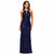 A woman modeling a sleeveless, floor-length navy blue gown covered in shimmering sequins and floral lace, set against a plain white background.