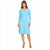 A woman modeling a light blue long-sleeve knee-length dress with a small keyhole cutout at the neckline, paired with beige high-heeled sandals, against a plain white background.
