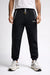 Person wearing black Reebok sweatpants on a white background