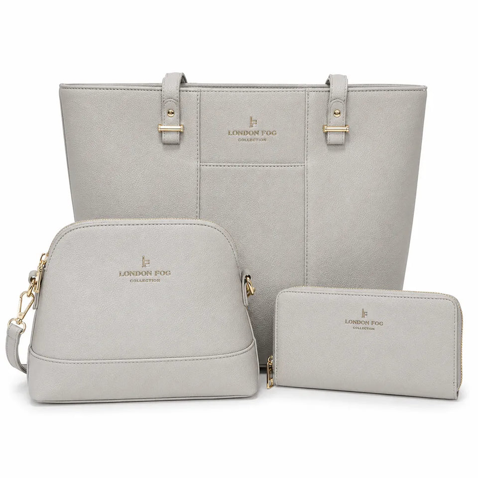 A three-piece London Fog Collection handbag set in light gray faux leather, including a large tote bag, a medium shoulder bag, and a slim wallet, all with gold-tone hardware and logo embossing.