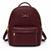 A burgundy pebbled leather backpack with gold-tone hardware, featuring a top handle, a front zippered pocket, and a gold brand plaque that reads 'LONDON FOR ALL'.