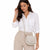 A woman wearing a white button-down shirt and beige trousers, carrying a beige crossbody bag with a small gold logo plate on a plain white background.