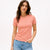 Woman wearing a pink t-shirt with text on a white background