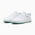 A pair of Puma sneakers in white with green accents on the outsole and heel tab, shown against a plain white background.