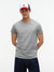 Man wearing a gray t-shirt and a cap with a visible brand logo on a white background