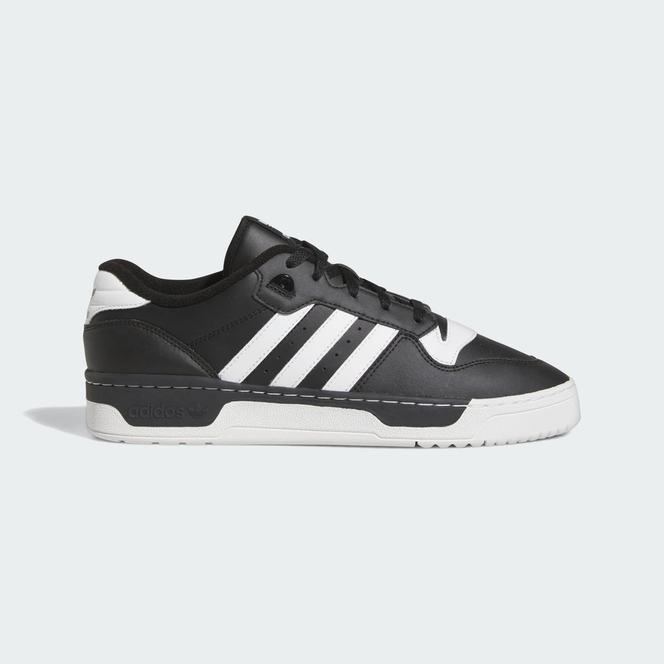 Black and white Adidas sneaker on a light gray background